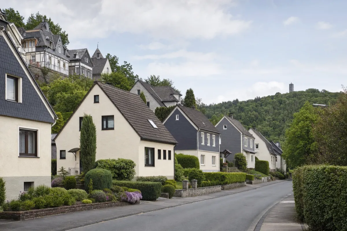 Wohnstraße in Iserlohn: die für die Stadt typische Bebauung, im Hintergrund über den Dächern ein Wahrzeichen der Stadt.